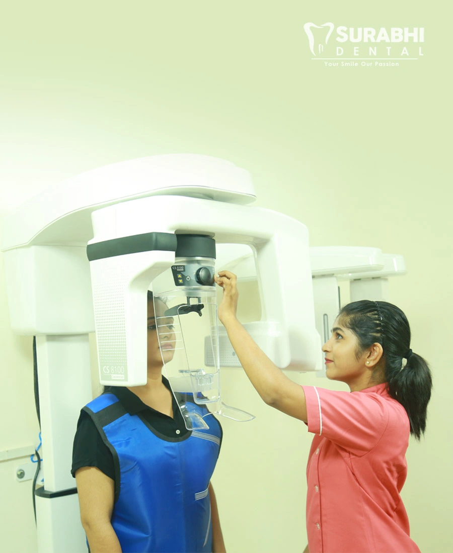 Dentist operating a dental X-ray machine with patient at Best Dental Clinic in Ernakulam, Kerala